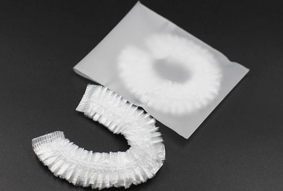 Ducha disponible elástico clara del hotel que baña los casquillos del salón de la cubierta del protector del cuidado del cabello